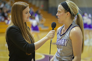 Student interviewing a basketball player