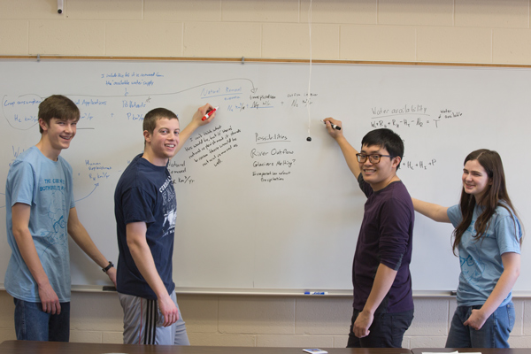 Math students posing at a whiteboard
