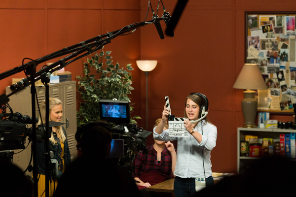 Students recording a sitcom on set
