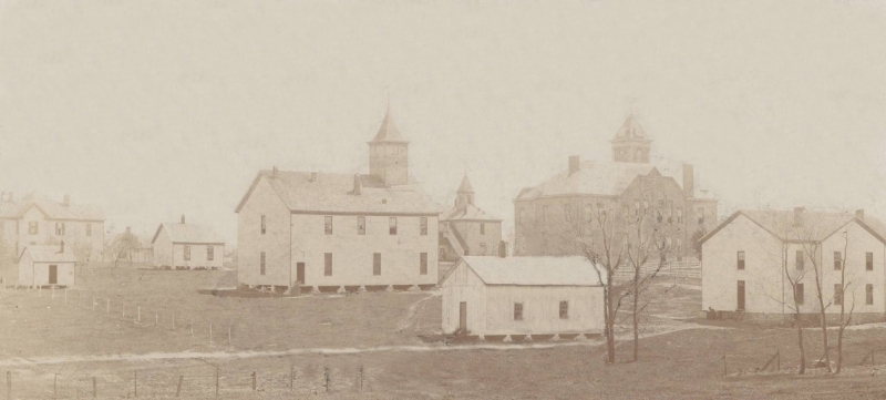 Old photograph of simple white buildings
