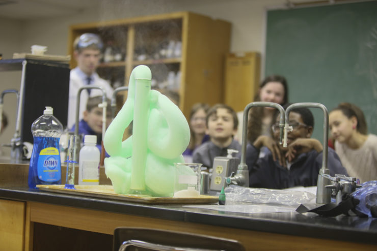 green foamy paste coming out of a graduated cylinder