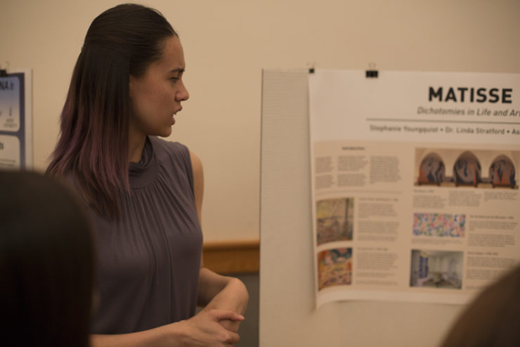student giving a poster presentation