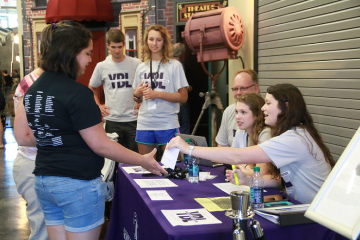 students registering at a table