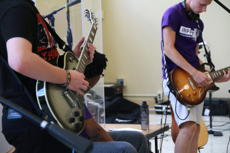 students playing guitars