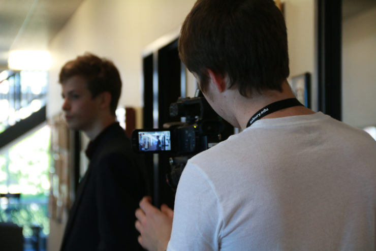 student operating a video camera