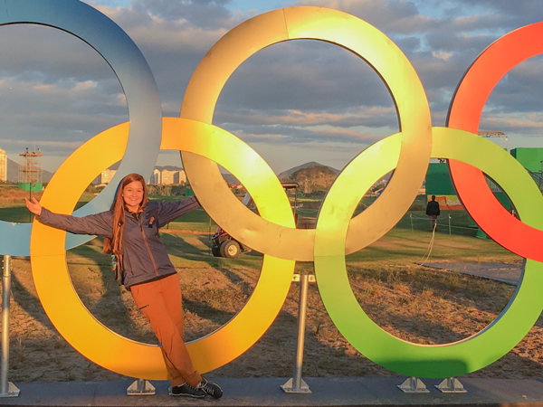 Student posing by Olympic Rings