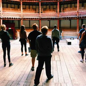 Students standing on the stage of Shakespeare's Globe Theatre