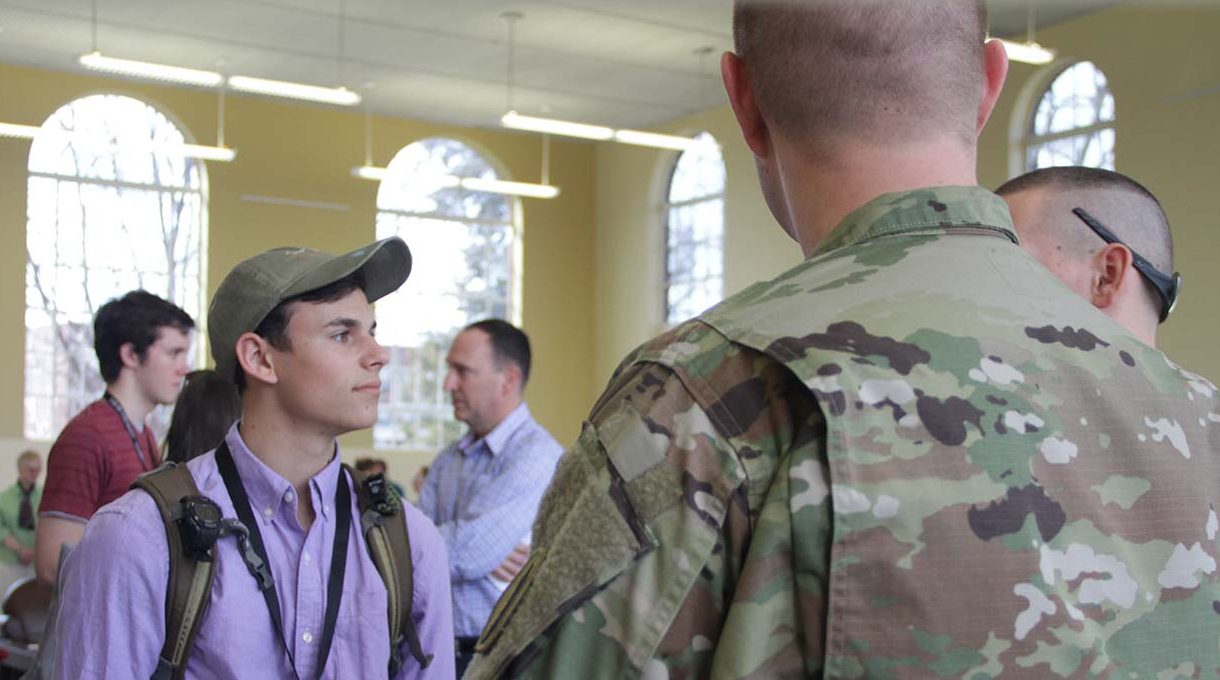 student talking to ROTC representatives