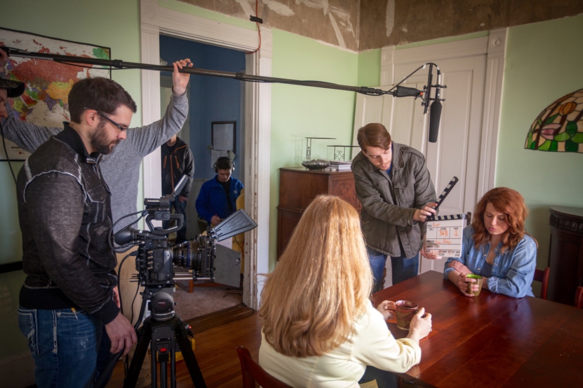 Students filming in a dining room