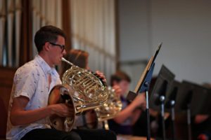 student playing a French horn