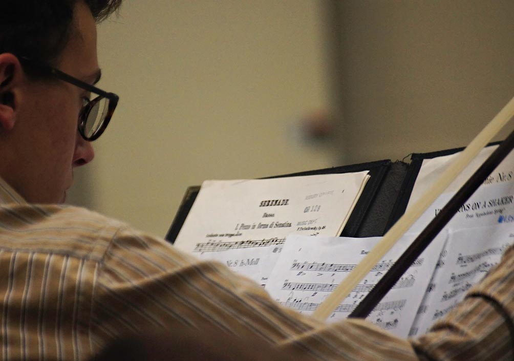 orchestra student looking at sheet music