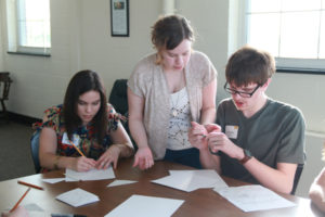 Three students at a table solving math problems