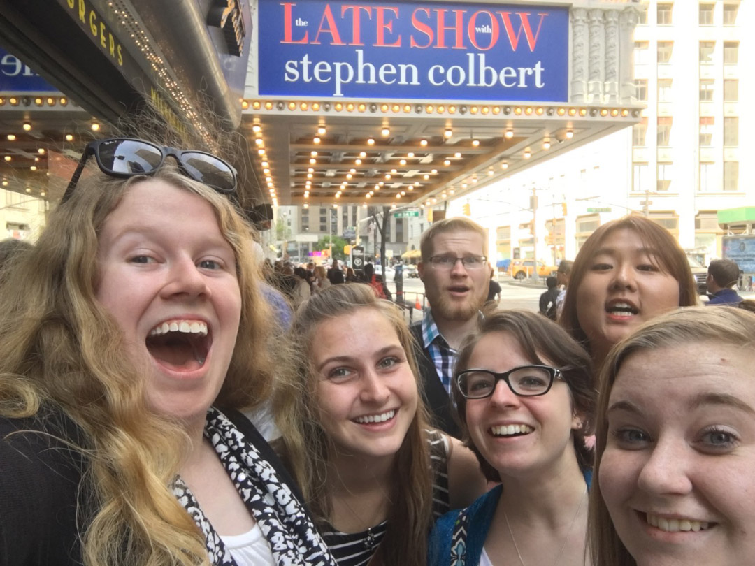 Students posing in front of the Late Show marquee