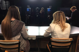 student presenters prepare for a news broadcast
