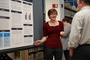 Student making a presentation at a poster