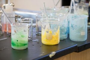 beakers with colored substances