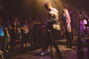 Student playing guitar at a concert