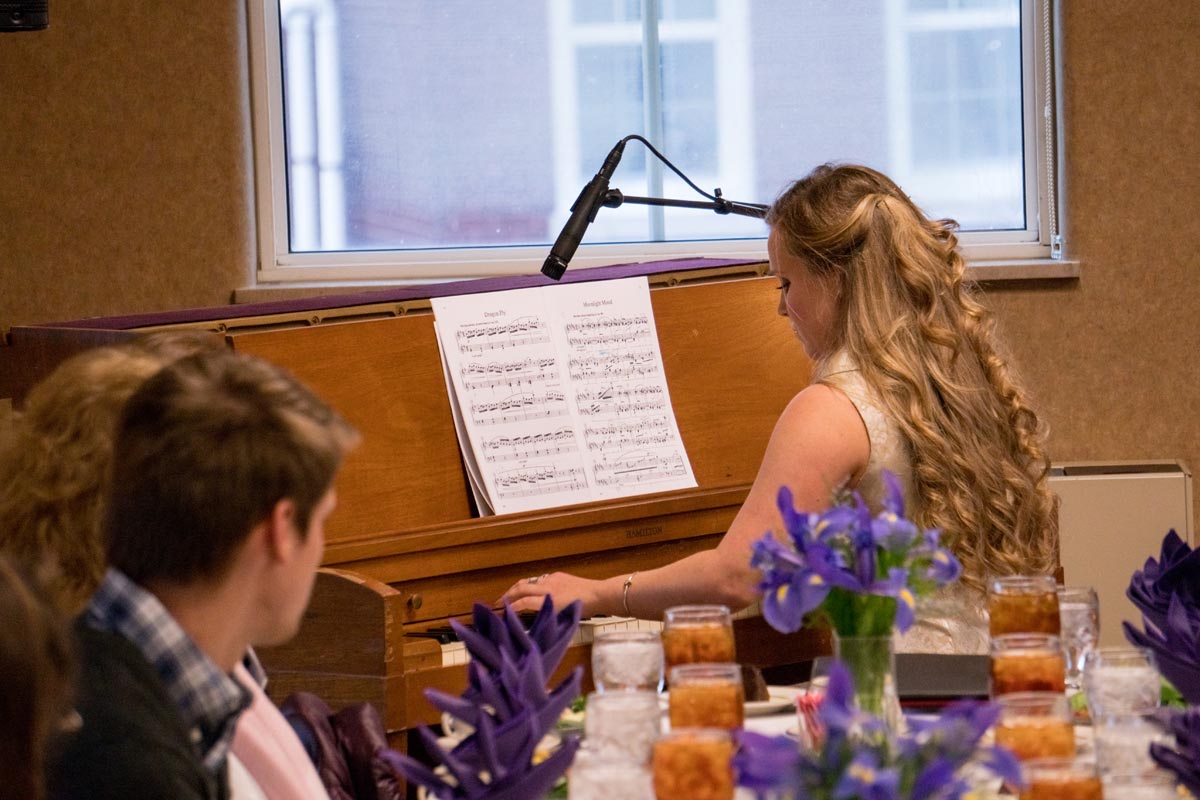 student playing piano at a banquet