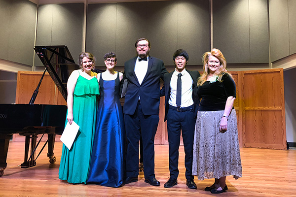Student musician honors recipients standing together on stage