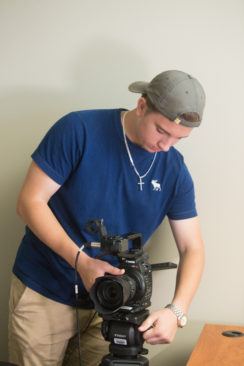 student using a movie camera