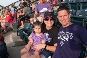 family in the stands at a baseball field
