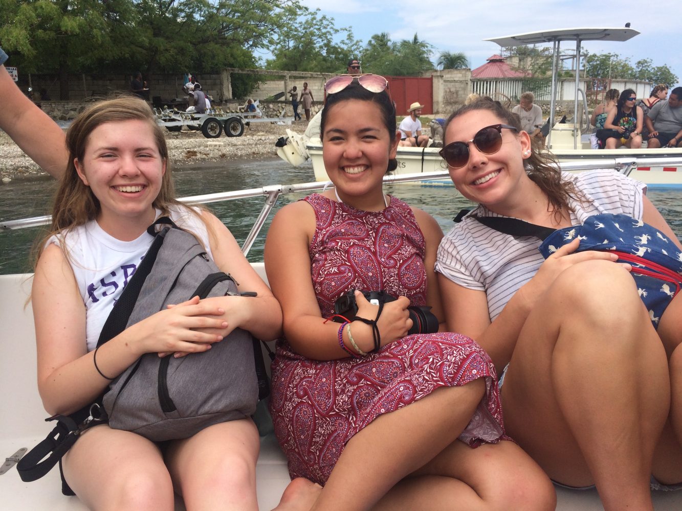 smiling students on a boat