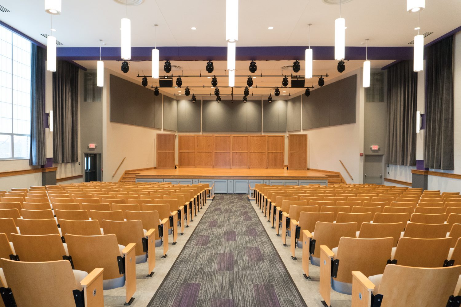 recital hall with seats, stage, and lighting