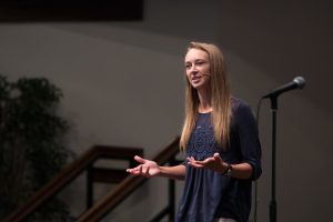 student speaking in chapel
