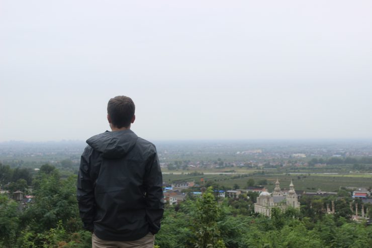 student standing at an overlook in China