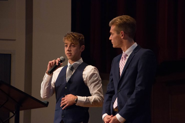 students speaking at a conference