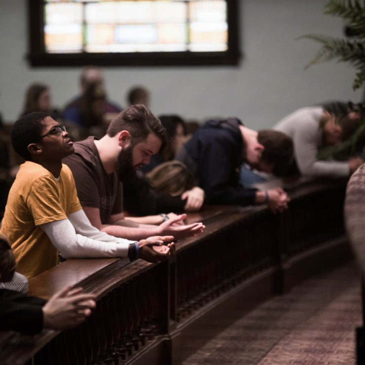 students praying in chapel