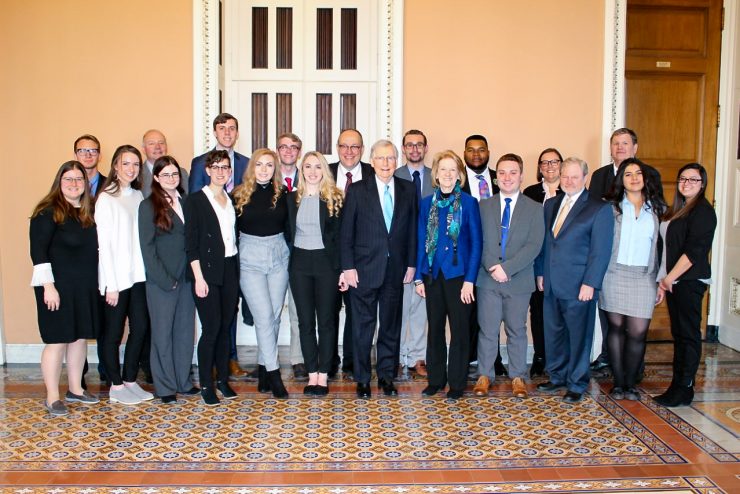 group photo of students, faculty, and politicians