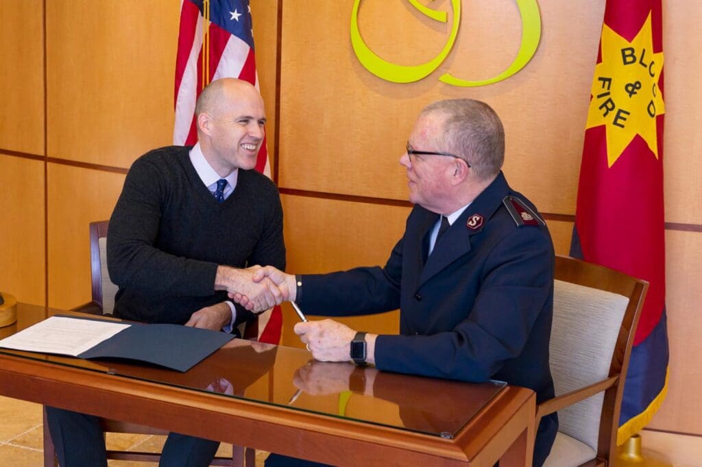 Dr. Brown shaking hands with a Salvation Army officer
