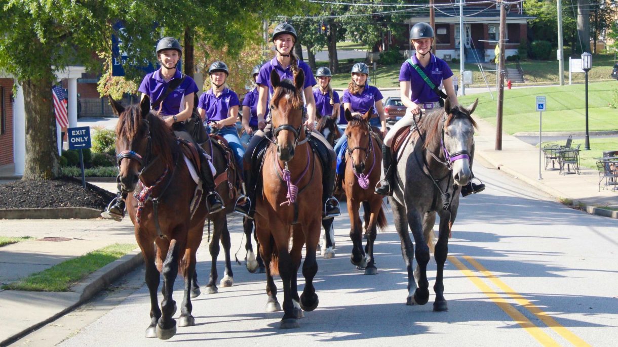 students riding police colts on Main Street