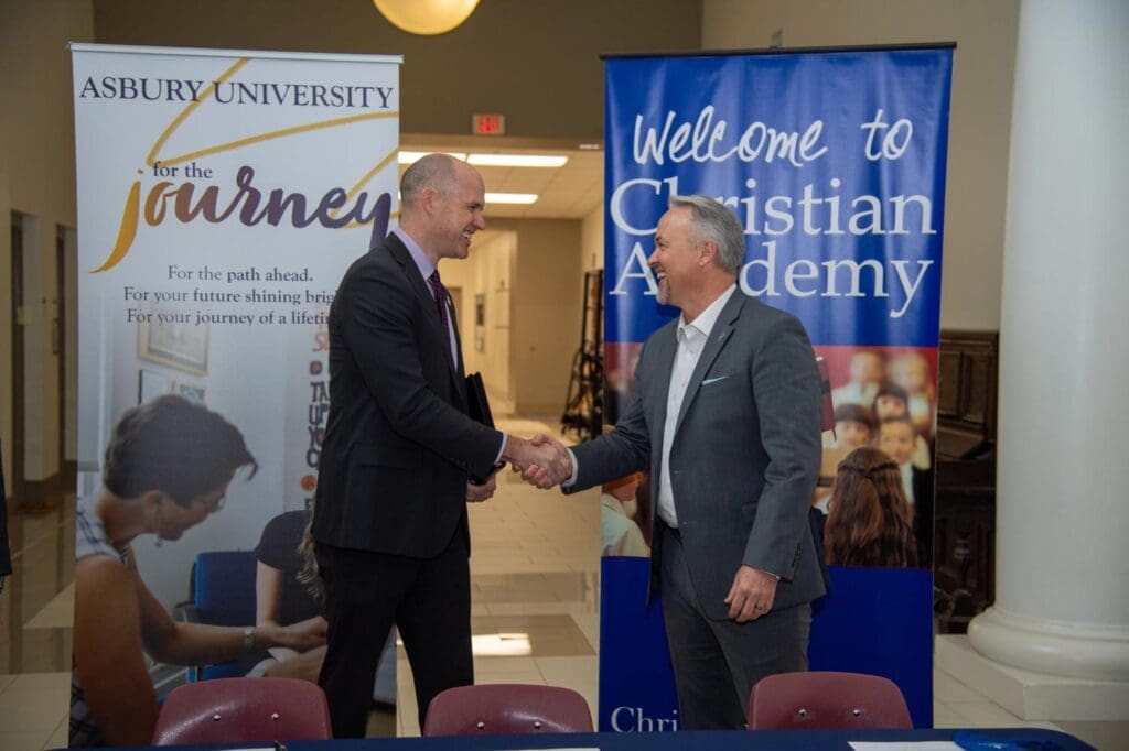 Asbury University President Dr. Kevin Brown and CAL High School Principal Robbie Brown shaking hands