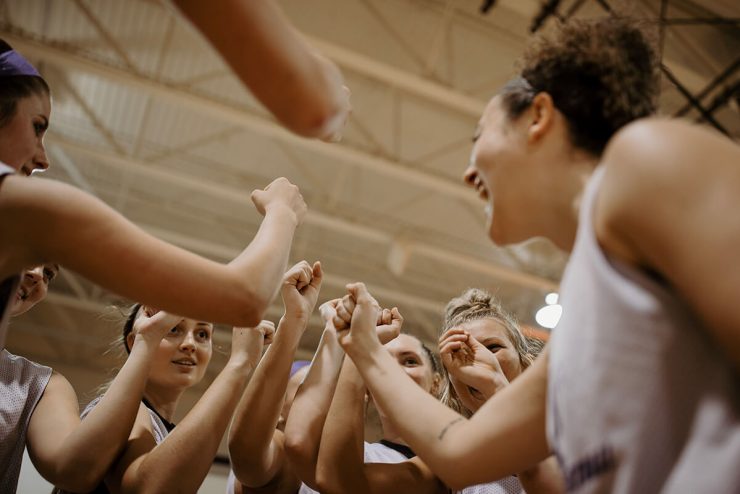 Asbury University women's basketball team in a huddle ready to play