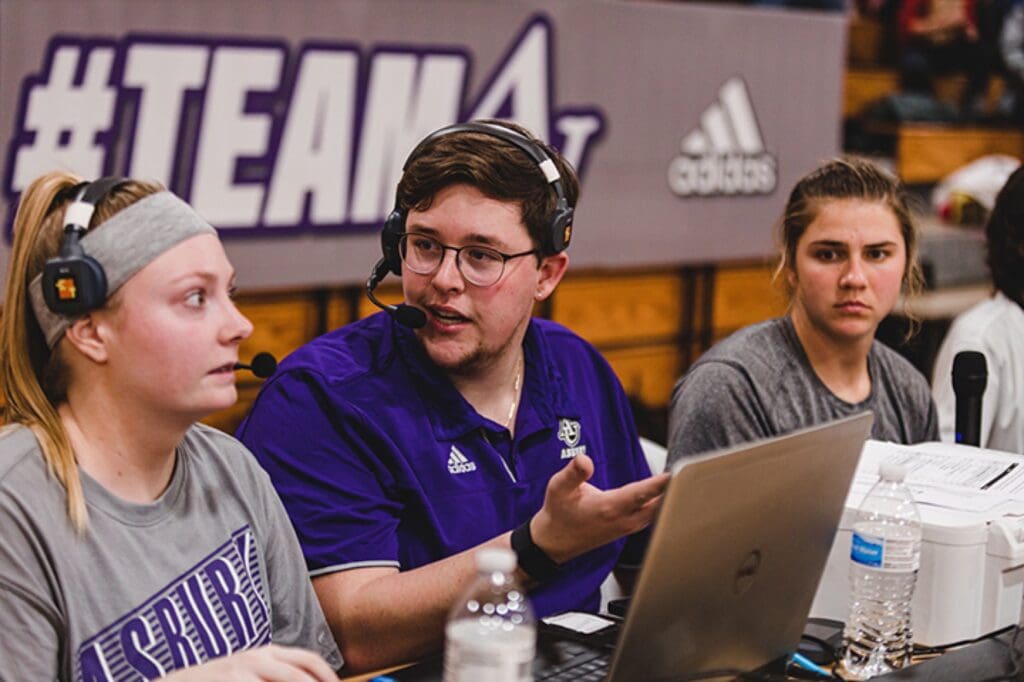 Student commentators at a basketball game