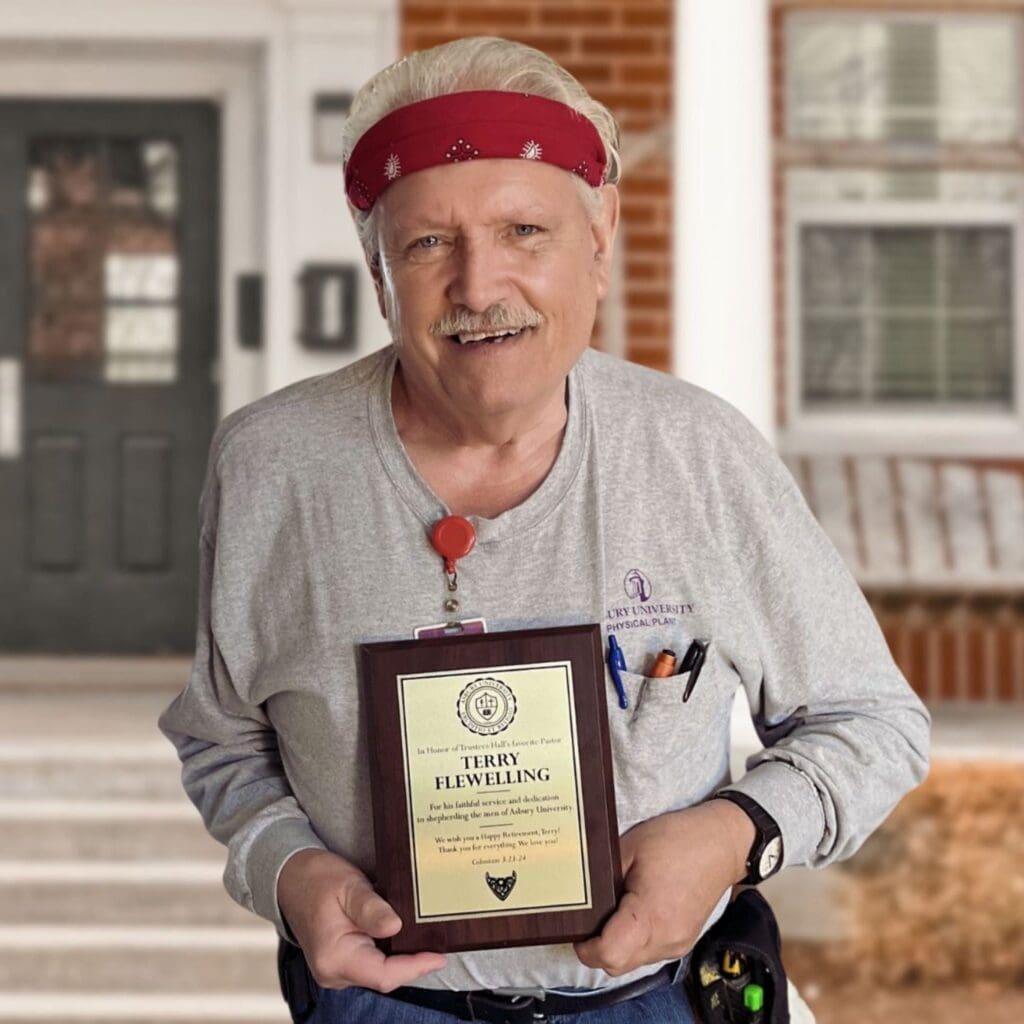 Terry Flewelling holding an award